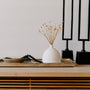white ceramic vase near two black table decors