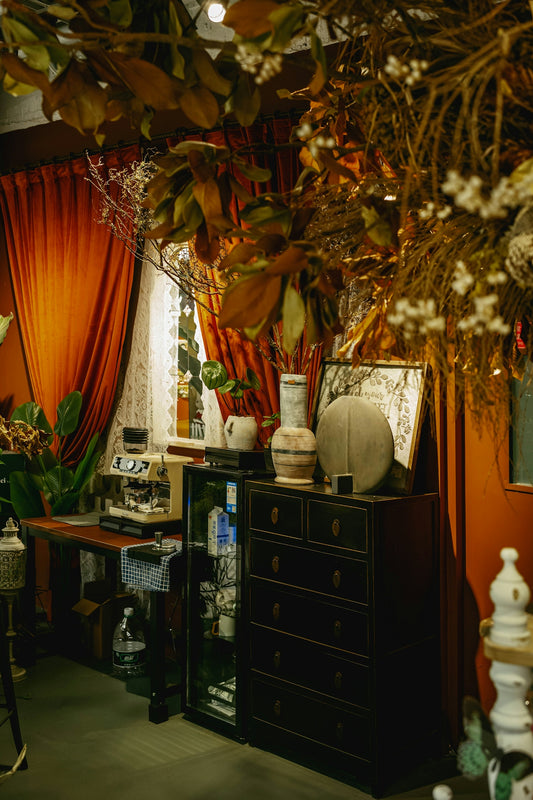 A dark room is decorated with autumnal decor.